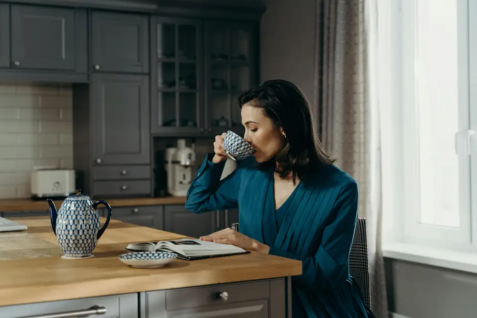 lady in kitchen drinking coffee