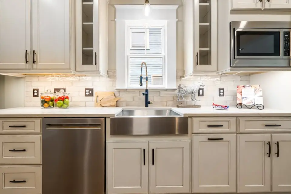 white cabinets with sink and window